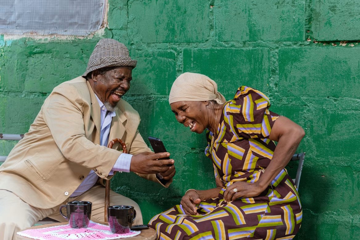 Customers laughing together at their phone